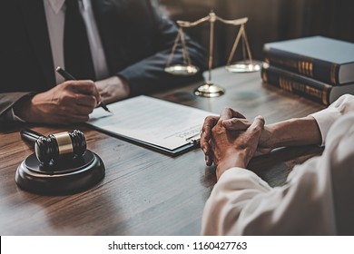 Judge gavel with Justice lawyers having team meeting at law firm background. Concepts of Law and Legal services. - Shutterstock ID 1160427763