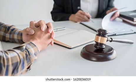 Judge gavel with Justice lawyers having team meeting at law firm background. Concepts of Law and Legal services. - Shutterstock ID 1620036019