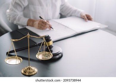 Judge gavel with Justice lawyers having team meeting at law firm background. Concepts of Law and Legal services. - Shutterstock ID 2093738944