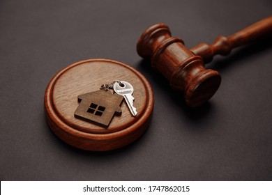 Judge gavel and key chain in shape of two splitted part of house on wooden background. Concept of real estate auction or dividing house when divorce, division of property, real estate, law system - Shutterstock ID 1747862015