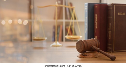 Judge gavel with law books and scales of justice. concept of justice, legal, jurisprudence. wide view. - Shutterstock ID 1141652915