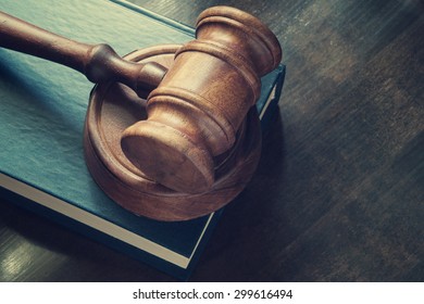 Judge gavel and legal book on wooden table
