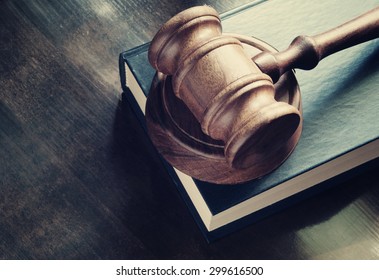 Judge gavel and legal book on wooden table, justice and law concept