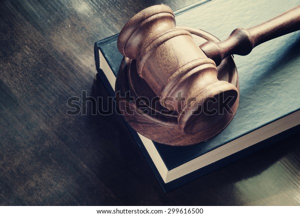 Judge gavel and legal book on wooden table,\
justice and law concept