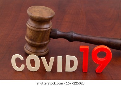 Judge Gavel With Letters Covid19. Concept Laws Against Covid-19.