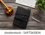 Judge gavel neart documents and keyboard - desk of contemporary lawyer - on wooden background top-down
