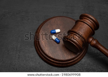Judge gavel and pills. Litigation Medicine-Related Healthcare in Pharmaceuticals. Law in medicine