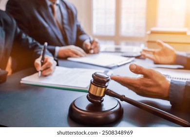 Judge gavel is placed on table in office of lawyer team It is gavel used as symbol of making decision in court case with fairness and ethics. judge gavel is prepared symbolize decision in court case.