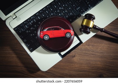 Judge Gavel With A Red Toy Car On The Computer Keyboard. Online Car Auction Concept