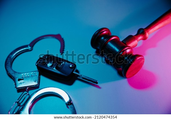Judge\
gavel and remote control from car in neon\
light