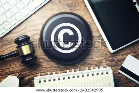 Judge gavel with tablet. Copyright. Intellectual Property