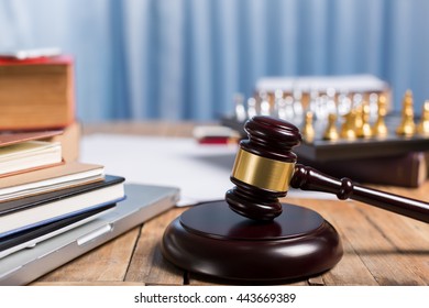 Judge gravel close up lawyer desk workplace, laptop, tablet, law book, golden chess checkers for legislation concept. - Shutterstock ID 443669389