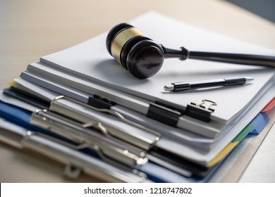 Judge hammer and business report papers, important documents