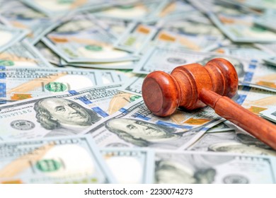 Judge hammer on American money background. Fraud tax fines. Law, judgment and justice concept. - Shutterstock ID 2230074273