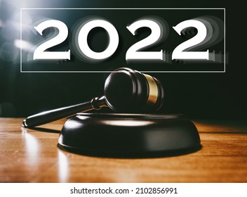 Judge hitting Gavel off a block in courtroom, dark background - year 2022 - change of law concept
