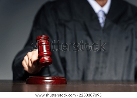 A judge hitting a mallet. Court. trial.