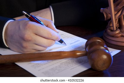 Judge. Male Judge In A Courtroom Striking The Gavel