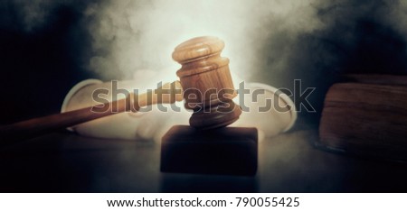 Judge. Male judge in a courtroom striking the gavel
