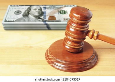 Judge Mallet Gavel With Unfocused 100 Dollar  Bills In Background
