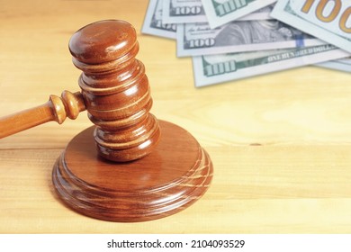 Judge Mallet Gavel With Unfocused 100 Dollar  Bills In Background
