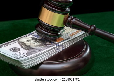 Judge and money concept. Judge's gavel on the table. Judge's hammer for verdict, justice judgment at courts of law. American One Hundred Dollar Bill, corruption, cost, finances, expenses, salary.