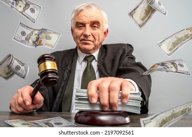 Judge And Money Concept. Judge's Gavel On The Table. Law Lord Wearing Gown Using A Hammer For Verdict, Justice Judgment At Courts Of Law. Dollars, Bill, Corruption, Cost, Finances, Expenses, Salary.