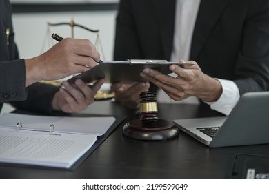 judge on wooden table And experienced lawyers meet with clients and give advice behind the scenes. legal services legal consulting concept - Shutterstock ID 2199599049