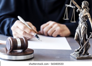 Judge with wooden gavel on table