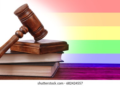 Judge's Gavel And Books On Wooden Table. Gay Rights Concept