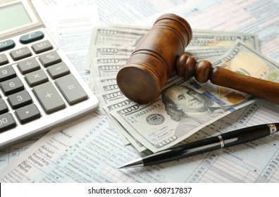 Judge's Gavel And Dollar Banknotes On Income Tax Form Background