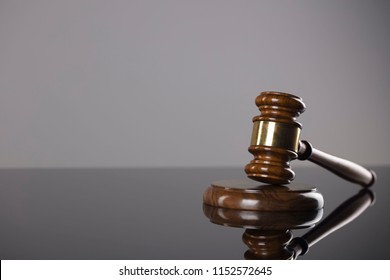 Judge's gavel on gray background.
