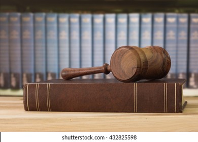 Judges gavel on law books with library background. Concept of legal education, cases study law.