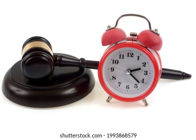Judge's gavel on its plinth next to a bell clock in close-up on white background - Shutterstock ID 1993868579