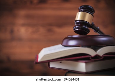 Judge's Gavel On Top Of Pile Of Law Books , Studio Picture On Wooden Background