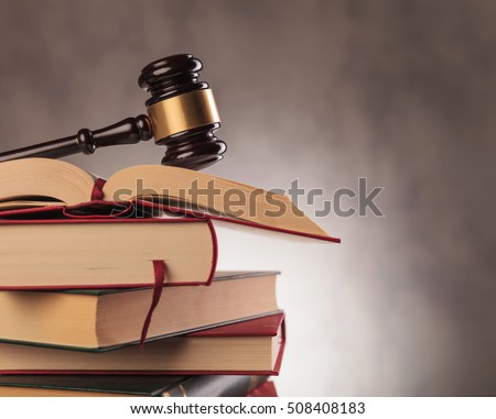 judge's gavel on top of a stack of books with copyspace in studio