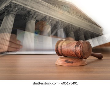 Judges Gavel On Wooden Table With Courthouse Background. Concept Of Legal,law.