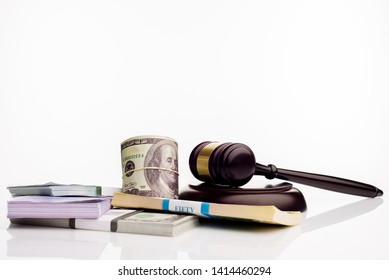 Judge's gavel and packs of dollars and euro banknotes on a white background. The concept of growing national debt- image