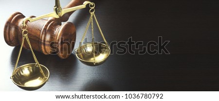 Judges Gavel And Scale Of Justice On The Black Table Background  In Back Light. Overhead View. Law Concept. Abstract Web Banner.