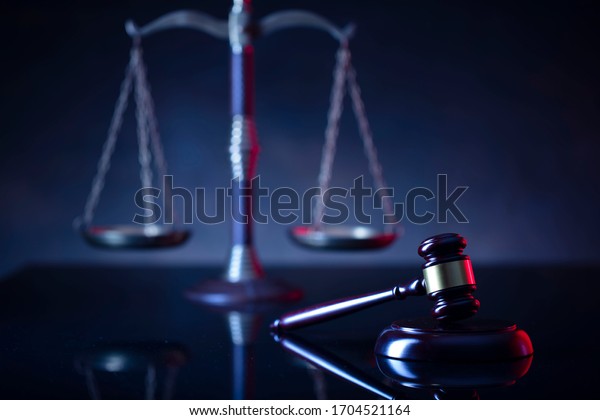 Judge\'s gavel, scales, statue of\
justice. Red light. Law and order social justice \
concept.