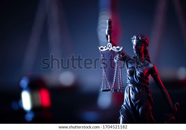 Judge\'s gavel, scales, statue of\
justice. Red light. Law and order social justice \
concept.