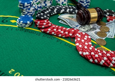 Judge's Gavel Stands Next To Playing Cards Poker Chips On Green Table. Responsibility For The Underground Casino. Illegal Gambling. Isolated