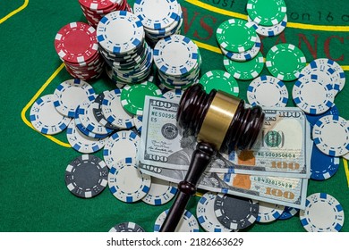 Judge's Gavel Stands Next To Playing Cards Poker Chips On Green Table. Responsibility For The Underground Casino. Illegal Gambling. Isolated