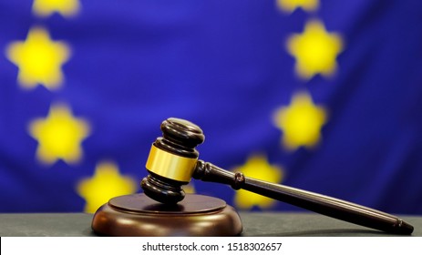 Judge's gavel. Symbol for jurisdiction. Law concept a wooden judges gavel on table in a courtroom or law enforcement office on blue background. european union flag background.