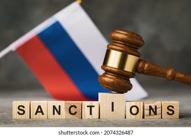 judge's gavel, wooden cubes with the text on the background of the Russian flag, the concept on the topic of sanctions in Russia - Shutterstock ID 2074326487