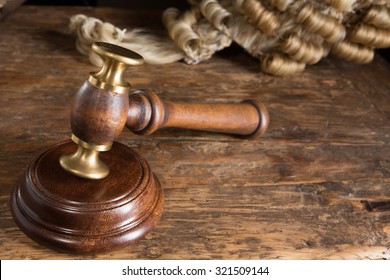Judge's hammer or gavel and his horsehair wig