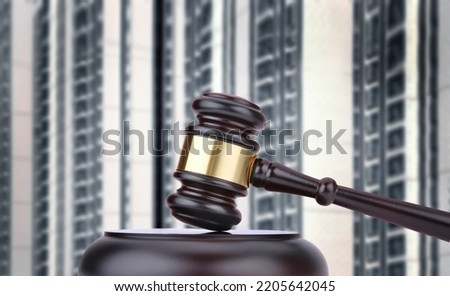 Judges hammer and residential building. Confiscated housing. Resolving property disputes