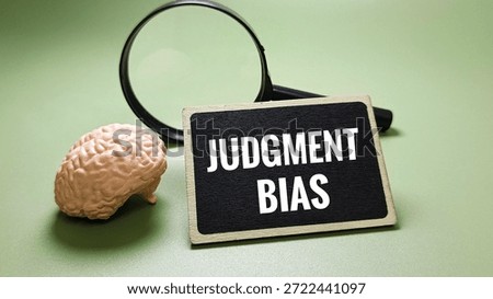 Judgment bias concept with brain model and magnifying glass on chalkboard illustrating cognitive bias, decision making errors, thinking process, and human prejudice. 