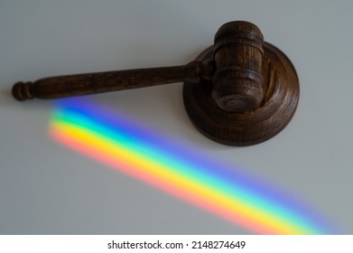 Judicial Gavel On A Table With A Rainbow Light Prism. 