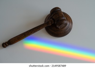 Judicial Gavel On A Table With A Rainbow Light Prism. 