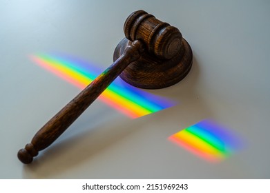 Judicial Gavel On A Table With A Rainbow Light Prism. 